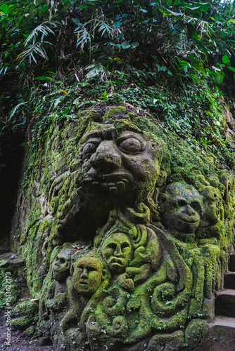Wallpaper Mural A moss-covered stone sculpture in a tropical jungle in Bali, Indonesia Torontodigital.ca
