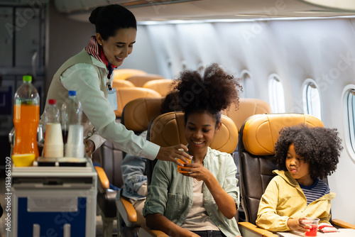 Passenger : African American sister and little girl traveling by an airplane. serving drinks.  Female steward serving glass of water for passengers on board. Flight attendant  and Cart on airplane