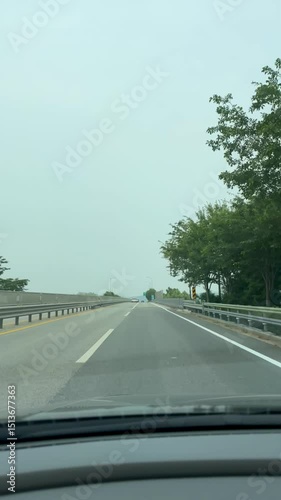 Driving on a quiet suburban road – POV with car hood view