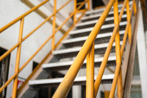 Fotografía Banister handrail with yellow painting of stairway platform at the factory place