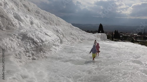 A family with young children and triplet daughters walks in Pamukkale, Turkey photo