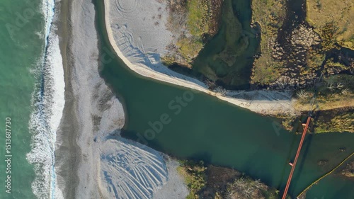 Discover an enchanting landscape along the Adjara coastline in Georgia, where the vibrant river flows into the vast Black Sea, intricately shaping the shoreline.