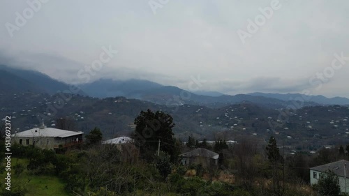 Explore the stunning landscape of Adjara, Georgia. This captivating aerial view reveals winding rivers, lush fields, and vibrant neighborhoods. Experience the natural beauty and tranquil environment.