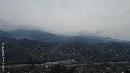 Explore the stunning landscape of Adjara, Georgia. This captivating aerial view reveals winding rivers, lush fields, and vibrant neighborhoods. Experience the natural beauty and tranquil environment.