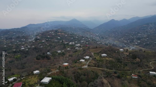Explore the stunning landscape of Adjara, Georgia. This captivating aerial view reveals winding rivers, lush fields, and vibrant neighborhoods. Experience the natural beauty and tranquil environment.