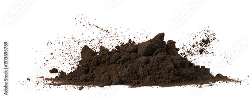 A pile of dark brown soil or dirt against a black background with some dust particles in the air around it