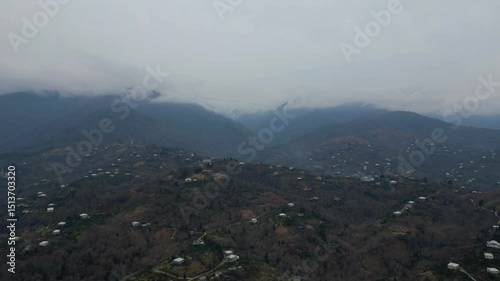 Explore the stunning landscape of Adjara, Georgia. This captivating aerial view reveals winding rivers, lush fields, and vibrant neighborhoods. Experience the natural beauty and tranquil environment.