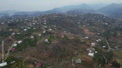 Explore the stunning landscape of Adjara, Georgia. This captivating aerial view reveals winding rivers, lush fields, and vibrant neighborhoods. Experience the natural beauty and tranquil environment.