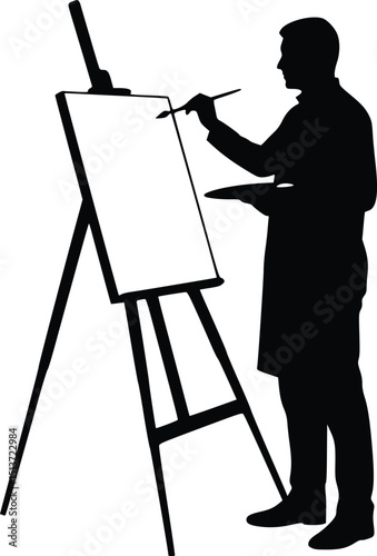 Silhouette of a focused artist painting at an upright easel, wearing a long coat