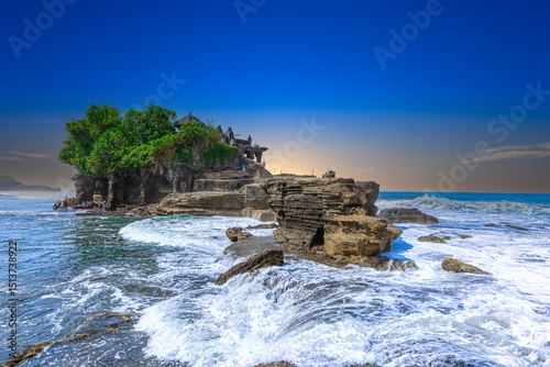 Tanah Lot Temple on the island of Bali known as the island of Gods. Sitting on top of rock island over looking turquoise blue beaches in Bali Indonesia