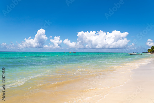 Fototapeta Naklejka Na Ścianę i Meble -  Beautiful Seascape: Calm Turquoise Ocean, White Sand Beach and Fluffy Clouds.Perfect Summer Getaway