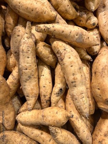 Fresh Sweet Potatoes Piled in Market Display
