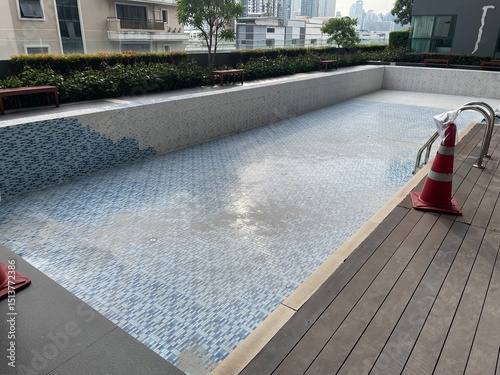 A swimming pool under repair, an abandoned swimming pool with no water in it