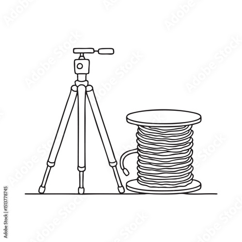 A tripod next to a coiled cable