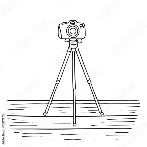A tripod with camera on a wooden deck