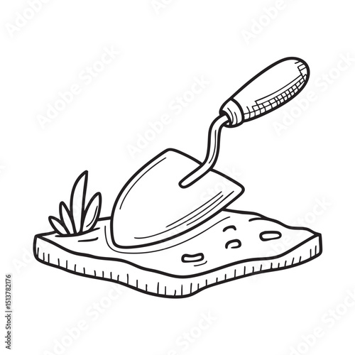A trowel lying on dry soil patches