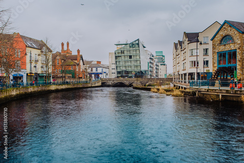 Fototapeta Naklejka Na Ścianę i Meble -  The town of Sligo, in the north of Ireland, straddles the Garavogue River where it meets Sligo Bay. This iconic view captures the heart of Sligo Town, showcasing its unique blend of urban charm
