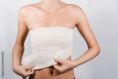 Zoomed-In Image of Women's Breast Bandaged with Elastic Wrap After Nipple and Areola Surgery.