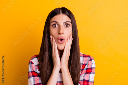 Photo portrait of shocked overjoyed smiling brunette isolated on yellow color background