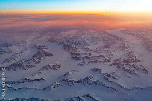 Aerial view of snow mountain and frozen river in colorful morning sunlight in Alaska