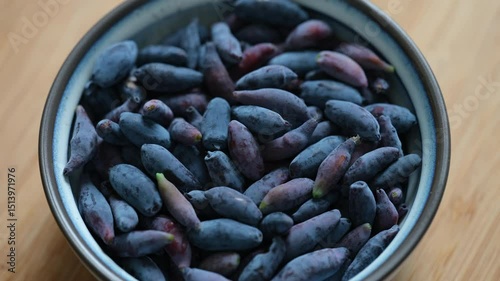 A bowl of freshly harvested honeysuckle berries. Close up.