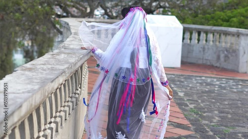 Indigenous woman wearing traditional clothes and veil posing in otavalo, ecuador