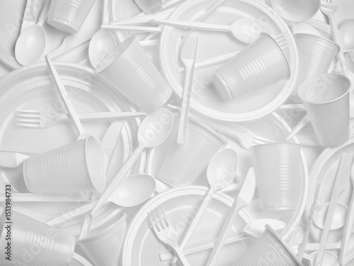 close up of plastic cutlery spoon, fork, knife, plate and cup on white background