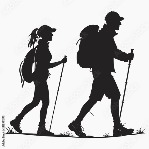 Silhouette of two adventurers hiking with backpacks and walking sticks at sunset