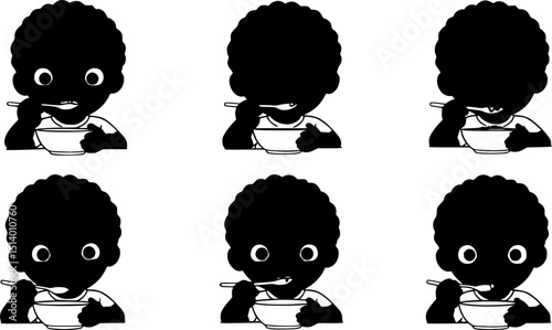 Happy child eating with a spoon. boy in black
