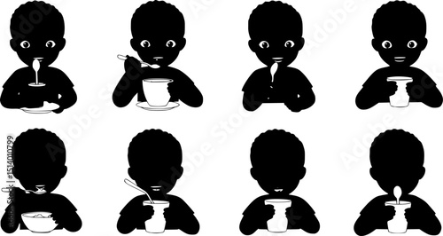 Happy child eating with a spoon. boy in black
