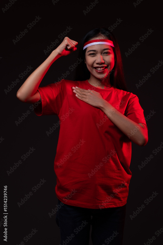 Fototapeta premium Portrait of Excited Young Asian Woman Wearing Red Outfit, Indonesian Independence Day Concept