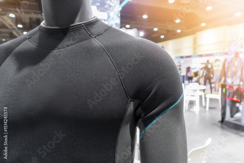 A diving or scuba diving suit is worn on a mannequin in a shop, with a perspective that emphasizes the torso and shoulders.