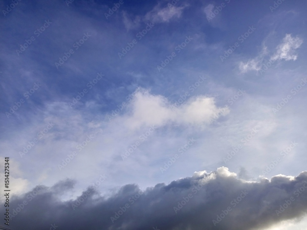 Fototapeta premium Blue Sky with Varied White and Grey Clouds