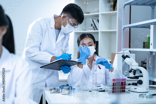 In the laboratory, several researchers conduct blood tests and analysis on samples, using science and medicine to advance their research and develop new treatments.