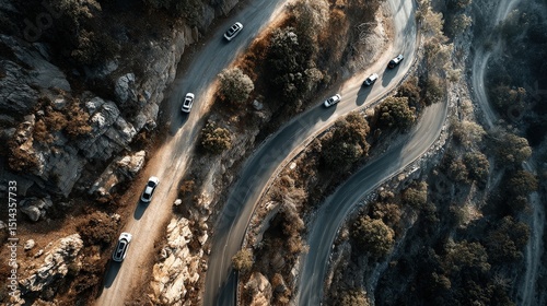 Winding mountain road with cars driving along a scenic route surrounded by lush greenery and beautiful landscapes