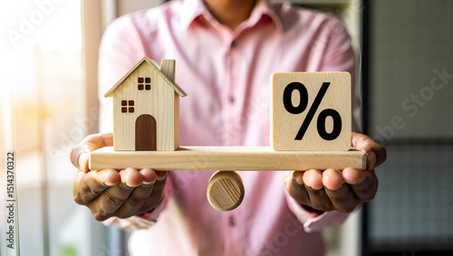 Balancing home ownership with interest rates, wooden house and percentage sign