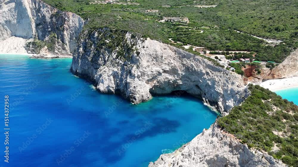 A backward receding aerial view of the Porto Katsiki headland, showing the sea caves and the beautiful beach on the side. Lefkada island, Greece.