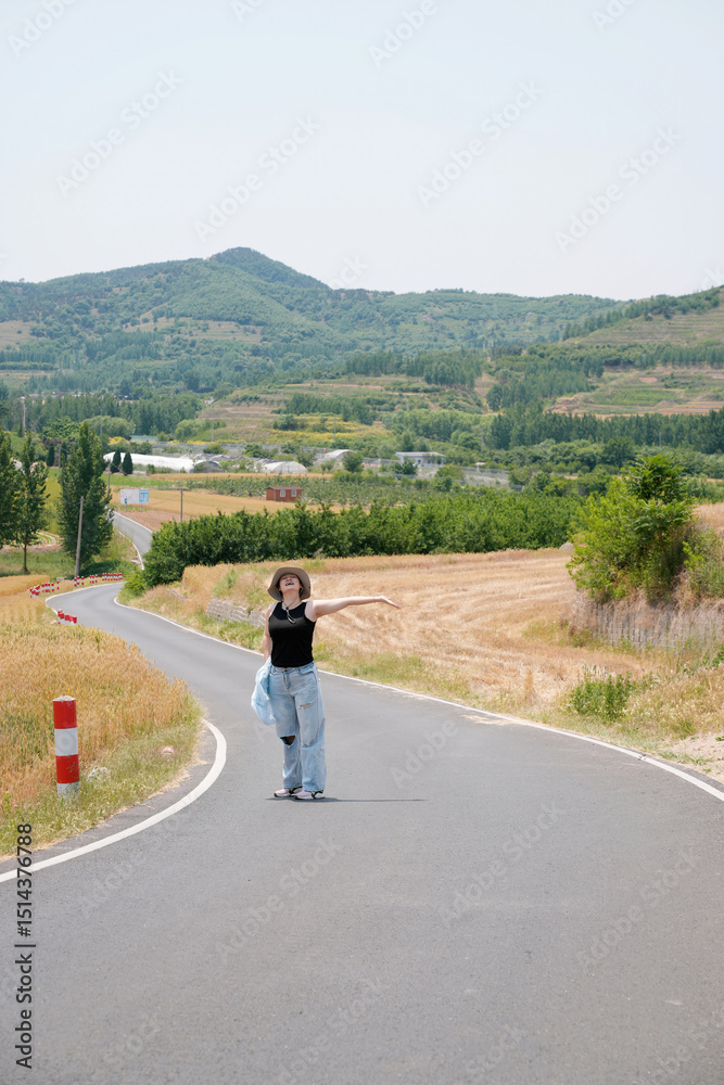 Fototapeta premium Woman Posing on Winding Country Road