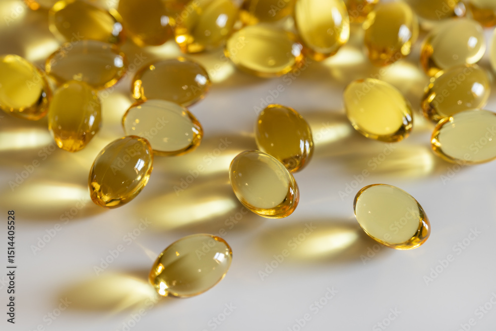 Yellow transparent capsules of fish oil on a gray background. Backgrounds and textures. Vitamins, healthy lifestyle. Yellow transparent capsules of fish oil on a gray background. Backgrounds and textures. Vitamins, healthy lifestyle.