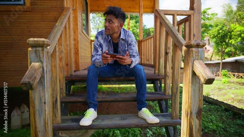 Day tripper entertains self with phone by stairs