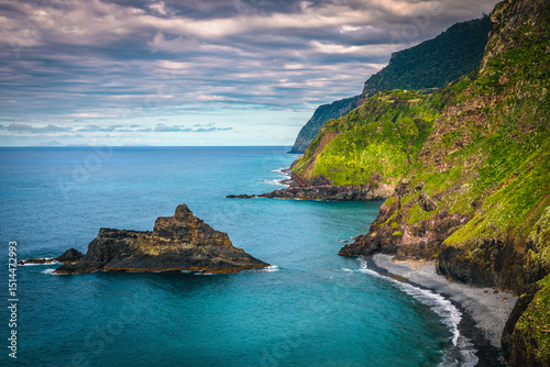 Amazing seaside view with colorful rocks and green steep slopes