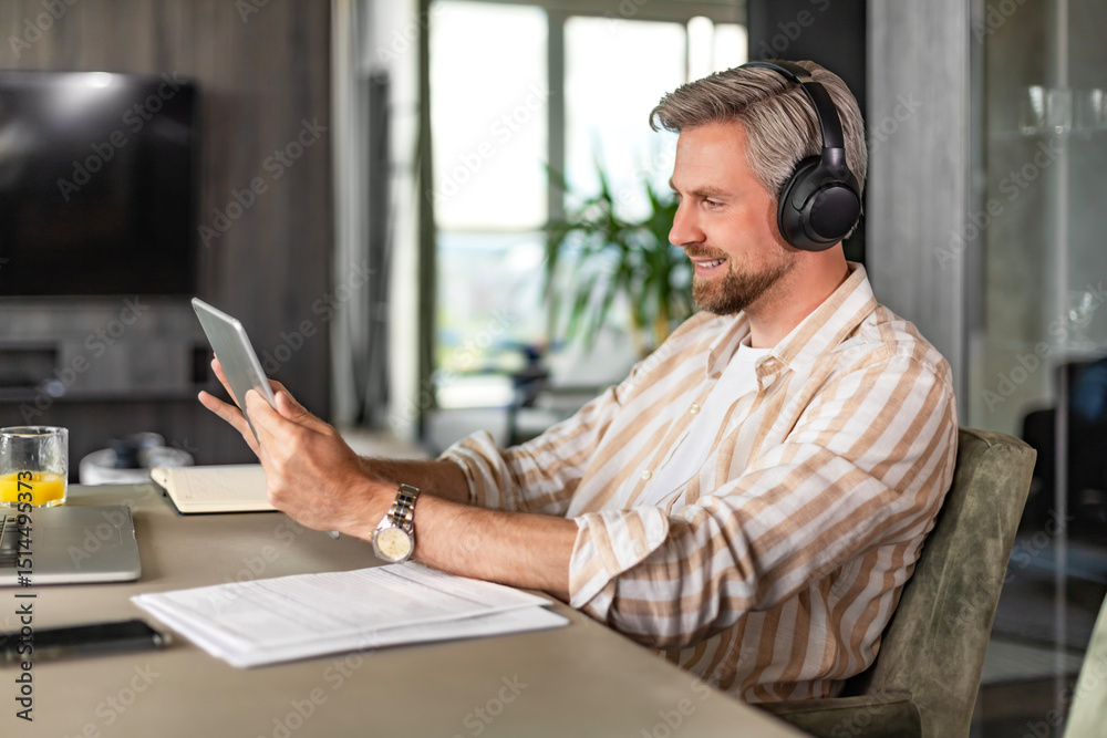 © ty - Confident man wearing headset speaking and watching business webinar training, listening to lecture. © ty - Confident man wearing headset speaking and watching business webinar training, listening to lecture.
