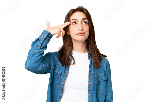 Fototapeta Young caucasian woman over isolated chroma key background with problems making suicide gesture