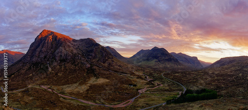 sunset over the mountains in scotland glencoe