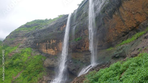 4K Wide angle shot of Kataldhaar waterfall flowing in full force during the monsoon season near Lonavala in Maharashtra, India. Scenic view of the waterfall in Sahyadri during the rainy weather.