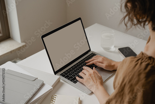 Close-Up of Hands Typing on Laptop at Clean Workspace with Notebooks, Neutral Aesthetic