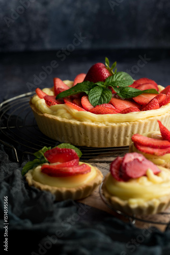 Homemade Strawberry Tart with Cream and Mint on Rustic Background