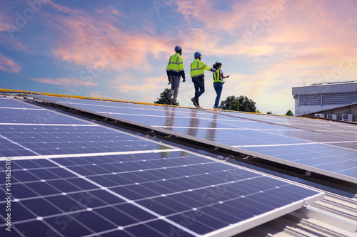 A team of engineers is laying out the installation of an outdoor solar panel system. Installing solar cells on the roof. Solar panels on the roof Workers install eco-technology photovoltaic power plan