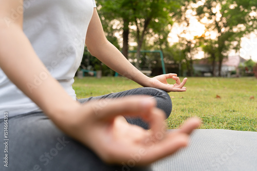 woman practicing meditate on the park. Asian woman doing exercises in morning. balance, recreation, relaxation, calm, good health, happy, relax, healthy lifestyle, reduce stress, peaceful, Attitude.
