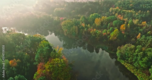 Misty river and autumn forest at sunrise.